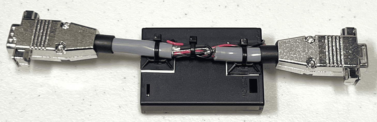 DB9 male-to-female cable insert with an inline AA battery holder providing photodiode bias